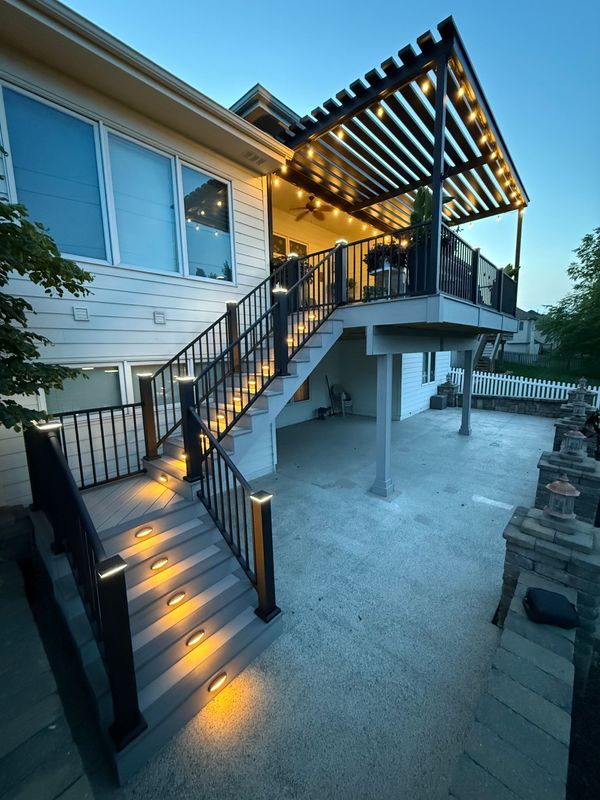 Multi-level composite deck with black aluminum railing overlooking a backyard in Omaha, NE