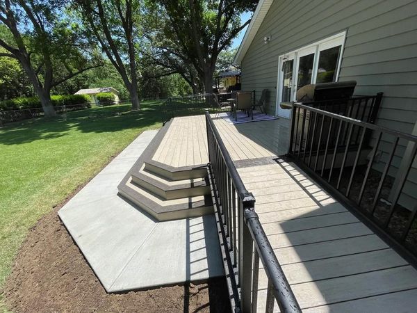 Wraparound composite deck with craftsman-style railing and built-in post lighting, Bellevue, NE