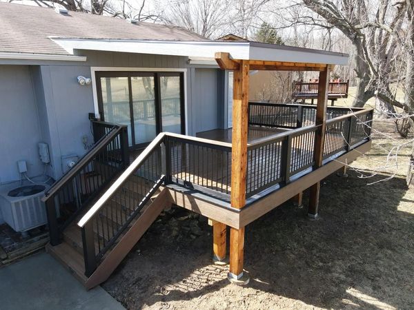 Two-story composite deck with privacy panels and staircase to the yard, Papillion, NE