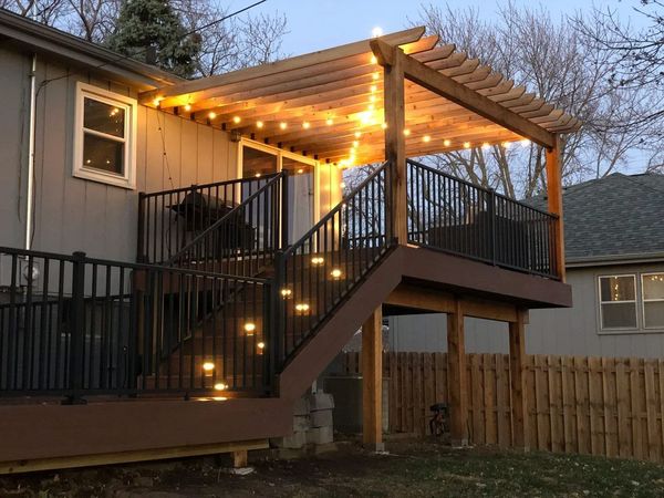 Single-level composite deck with cedar-accented railing detail and recessed step lighting, Omaha, NE