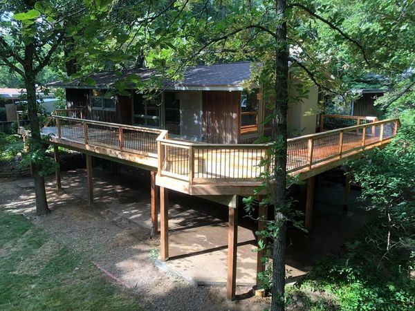 Composite deck with pergola overhead, hanging string lights, and wide-board decking, Omaha, NE