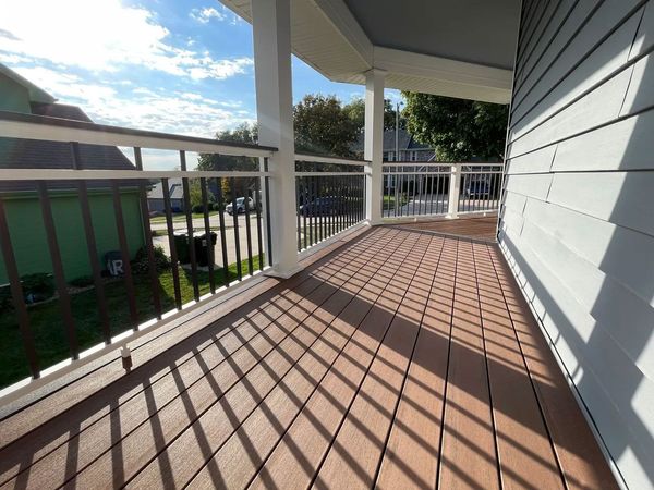 Backyard composite deck with built-in corner bench and low-voltage step lighting, Bellevue, NE