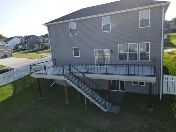 Multi-level Trex deck with angled stairs, cable railing, and built-in planter boxes, Papillion, NE