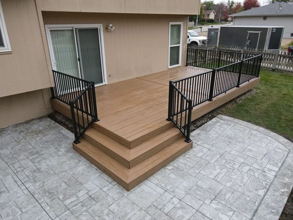 Ground-level cedar deck with lattice privacy screen and decorative turned post caps, Council Bluffs, IA