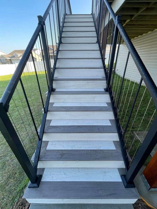 Large composite deck with covered porch section, ceiling fan, and glass panel railing, Elkhorn, NE