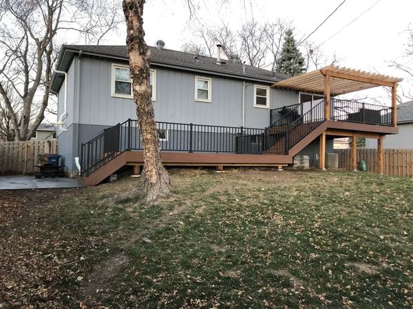 Composite deck with horizontal cedar accent railing and integrated low-voltage step lighting, Gretna, NE