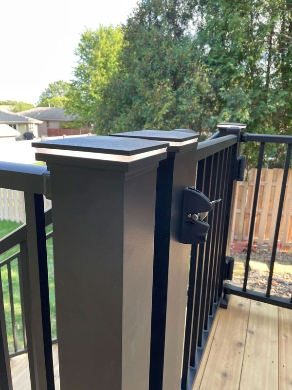 Multi-level composite deck with lower-level concrete patio and aluminum railing on upper deck, Omaha, NE