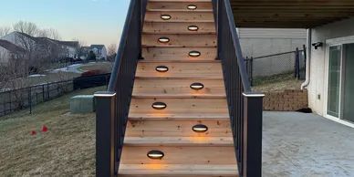 Large Trex composite deck with wrap-around bench seating, planter boxes, and glass panel railing, Bellevue, NE