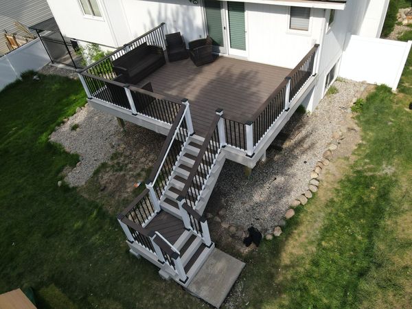 Multi-level TimberTech deck with full pergola, built-in bench seating, and cable railing, Elkhorn, NE