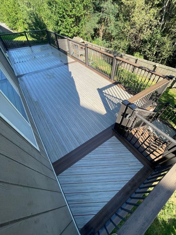 Cedar deck with diamond-pattern wrought iron railing and wide staircase to yard, La Vista, NE