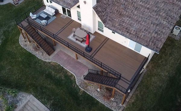 Two-level composite deck with pergola covering the upper tier and stainless cable railing, Millard, NE
