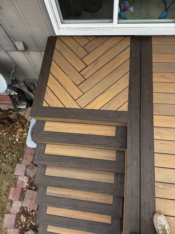 Single-level composite deck with built-in bench and lattice privacy panels on the side, Omaha, NE