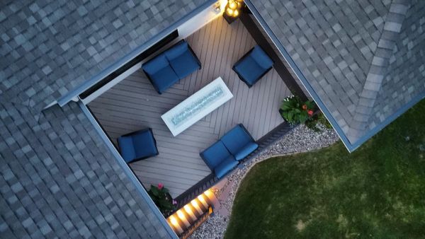 Large backyard composite deck with full pergola cover, privacy wall panels, and built-in bench seating, Bellevue, NE
